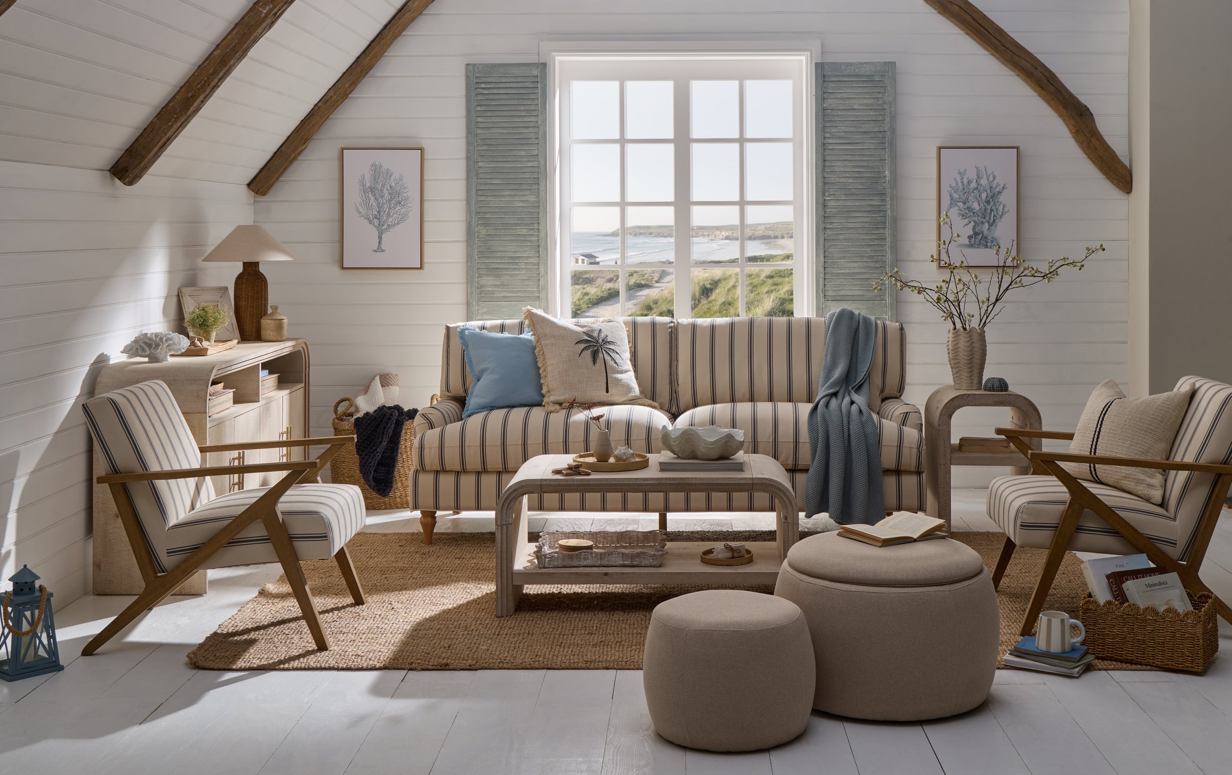Coastal living room with striped sofa, rattan textures, blue accents and relaxed beach house styling