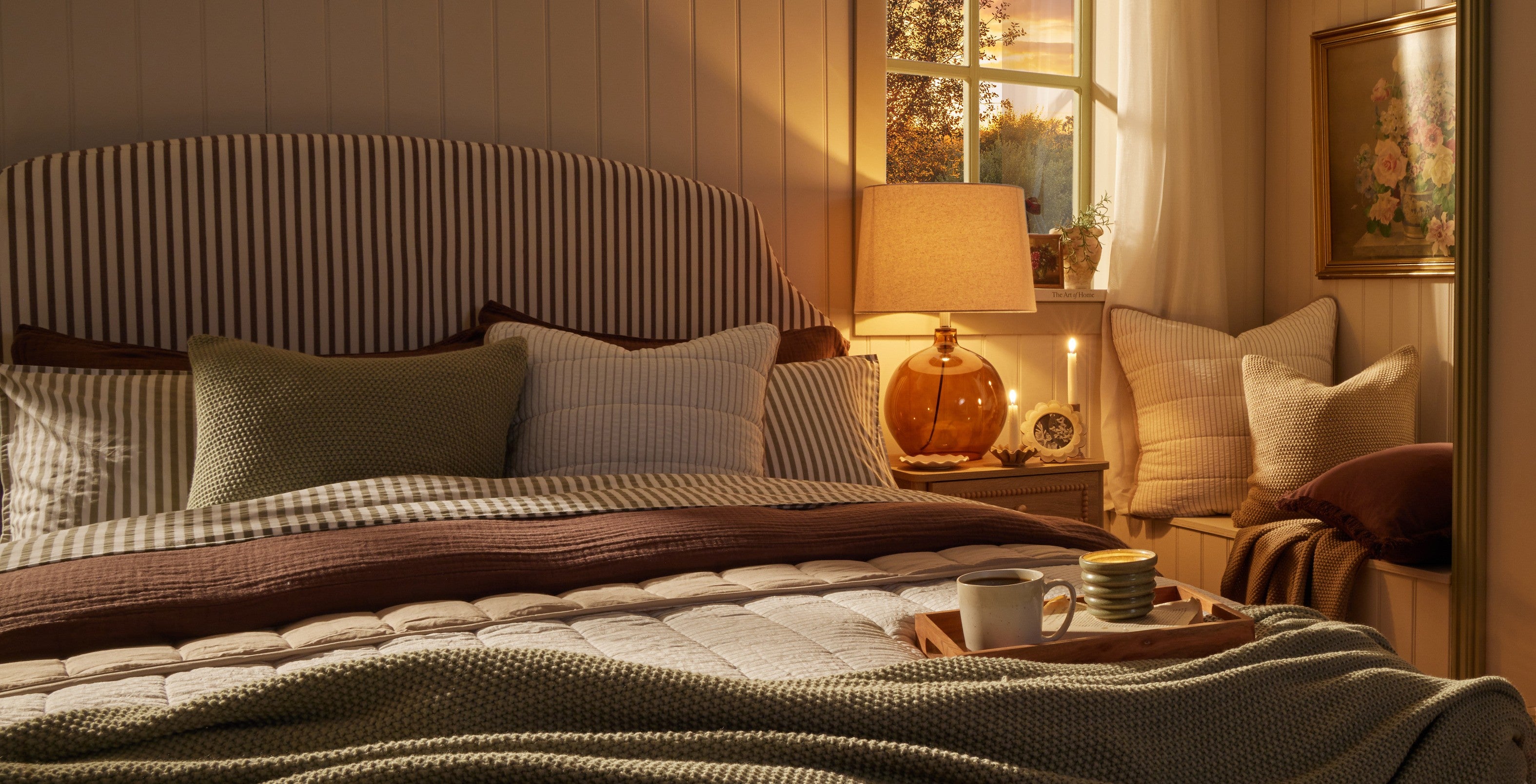 Striped bed with bedside table and lamp