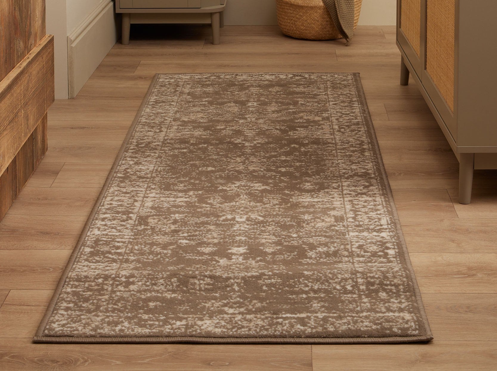 Neutral taupe hallway runner rug with a subtle pattern, styled on wooden flooring between hallway cabinets.