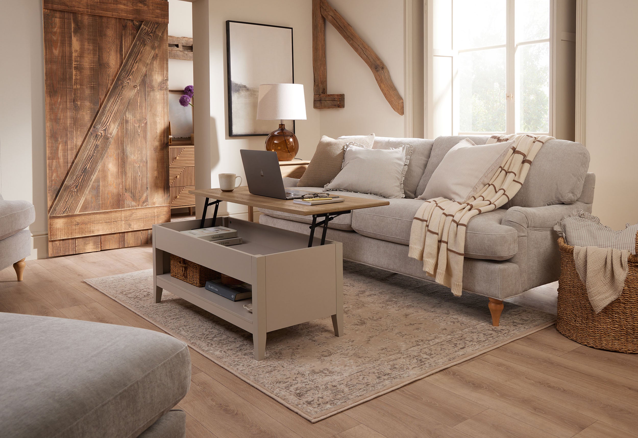 Willow lift-up coffee table in a soft taupe finish, styled in a living room with the top raised as a laptop workspace.