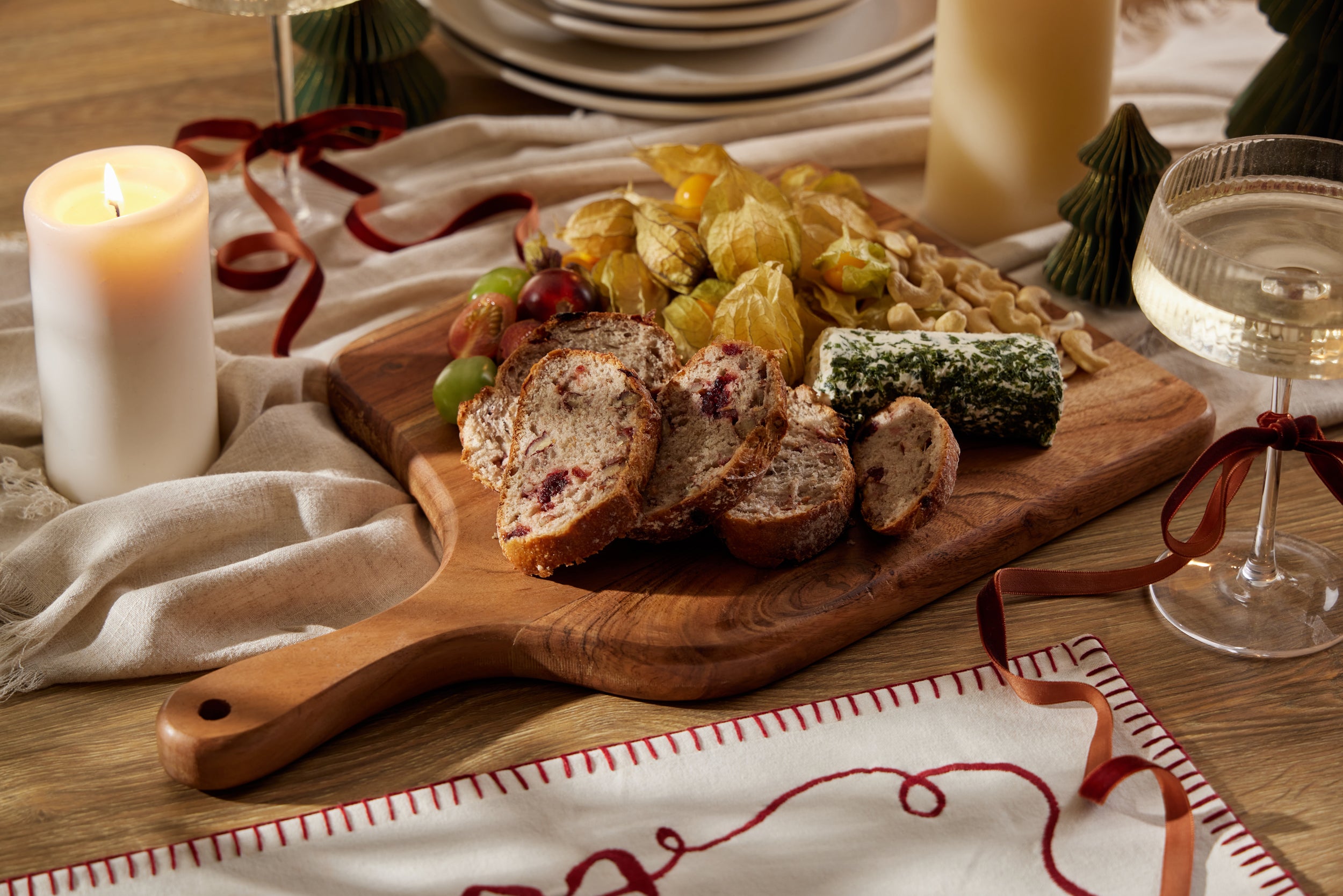 Wooden chopping board with festive charcuterie of cheeses
